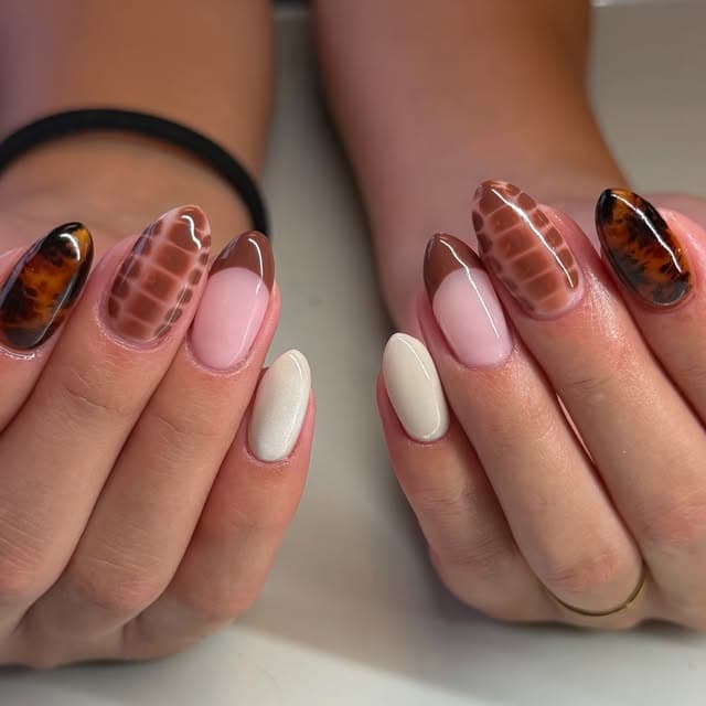 Bold brown and pink checkered nail art on almond-shaped nails